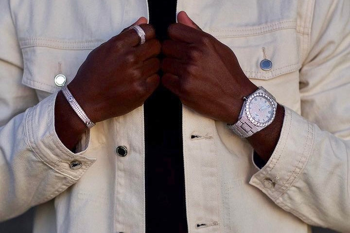 Black man wearing an iced out bracelet and watch