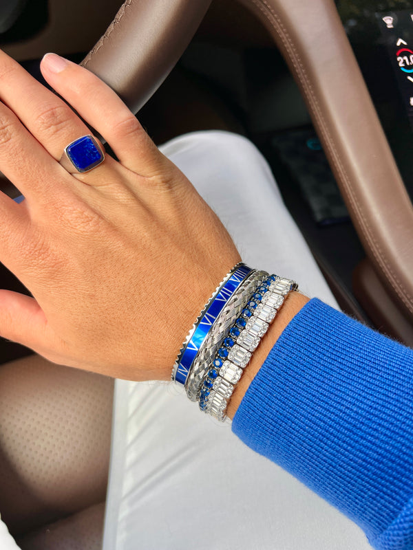 Man wearing 4 bracelets. Iced out Tennis bracelet Roman Speed bracelet and a lapis lazuli ring Emils Jewellery Online shop