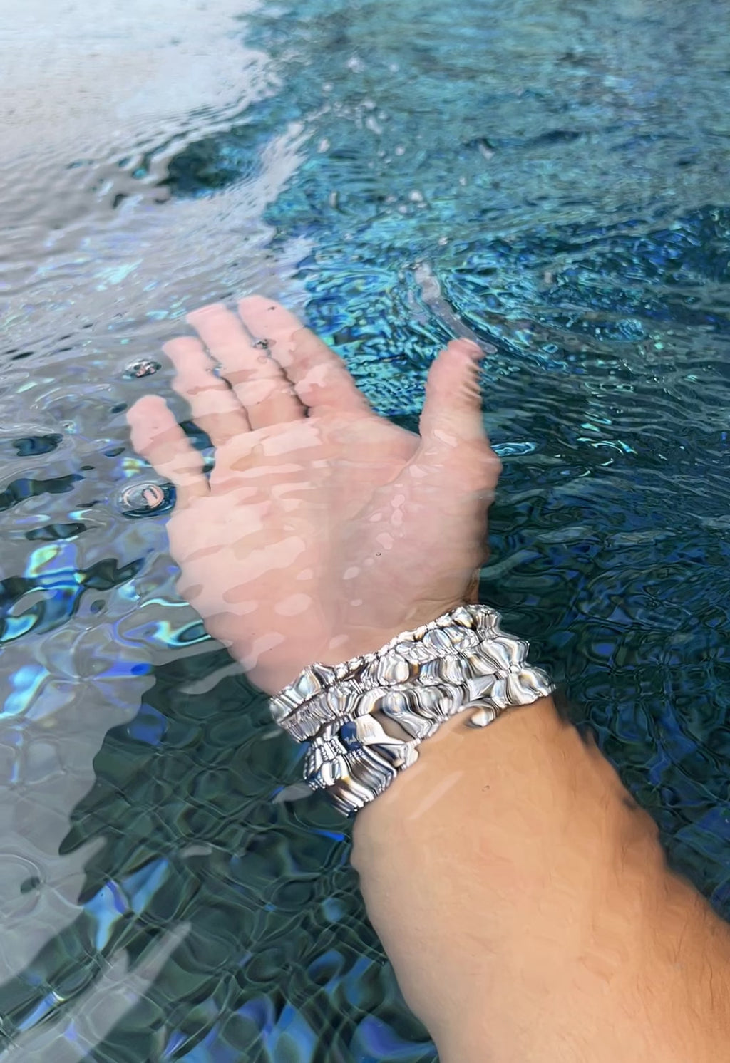 Video showing the quality of the iced out president bracelet in a pool